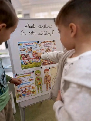 Copii la panoul despre alimentație sănătoasă